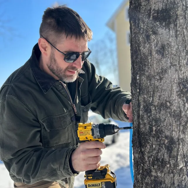 Eben tapping a maple tree in the snow