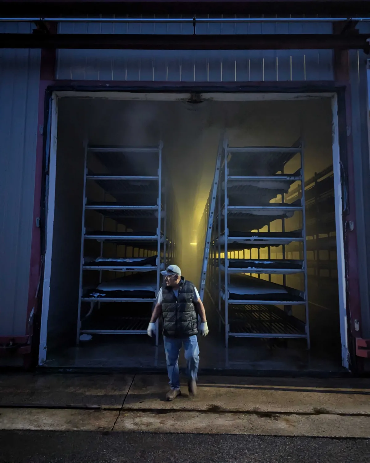 A farmer walking out of the grow room at our Pennsylvania mushroom farm